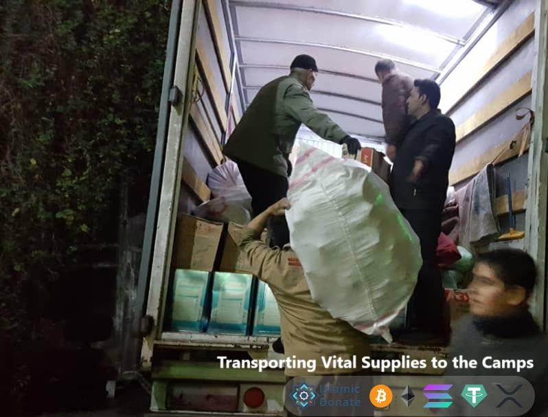 Volunteers load relief aid and food packages into a truck for Palestinian camps via cryptocurrency donation support.