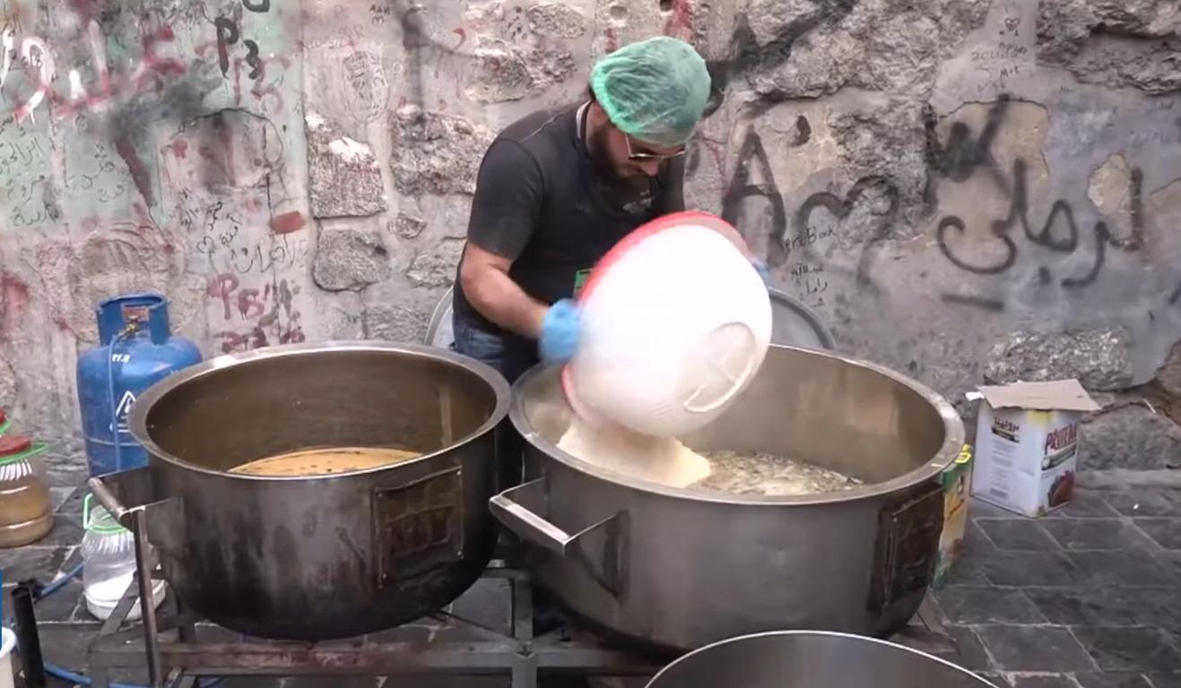 Man preparing food in large pots, distributing to the needy, with crypto donation support via Tron.