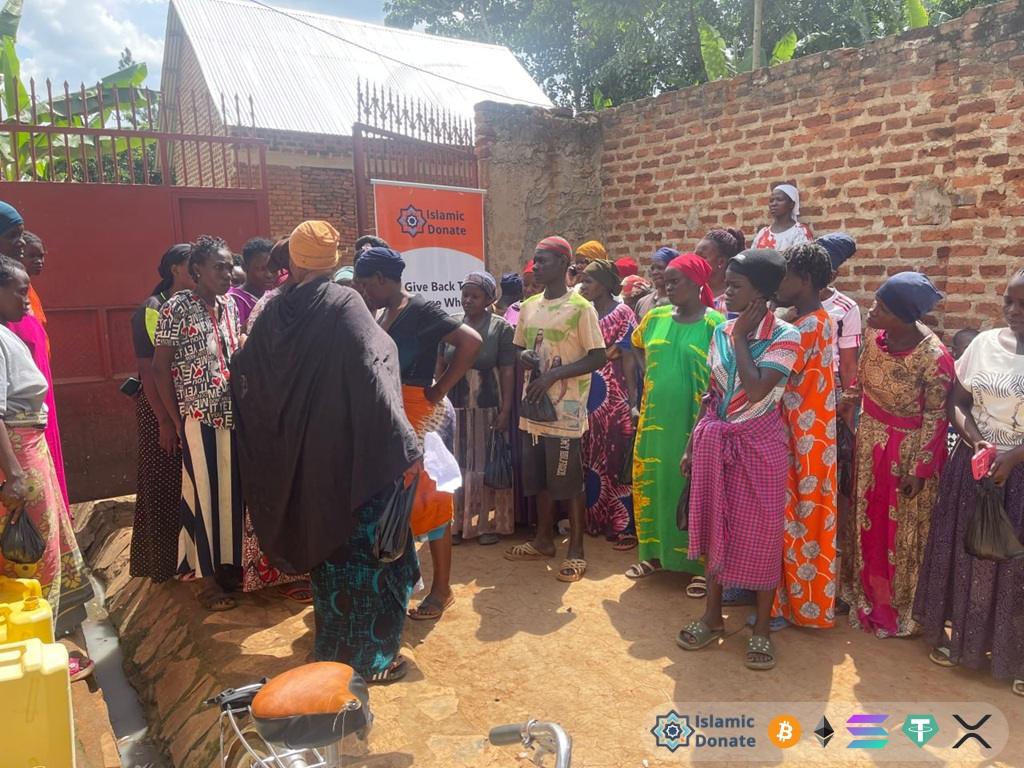 Women in local costumes stand together. Food relief in East Africa to community members facilitated by Arbitrum aid.