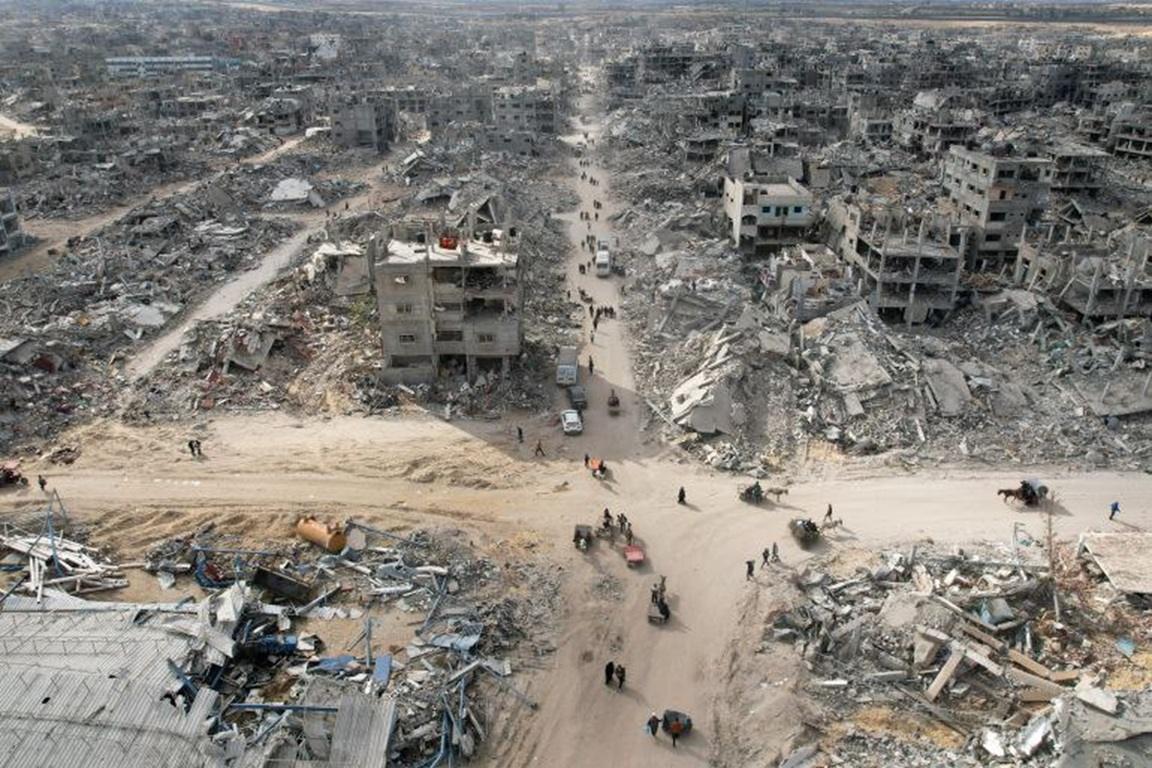 Aerial view of destroyed Gaza buildings and roads for humanitarian aid relief efforts funded by cryptocurrency support.