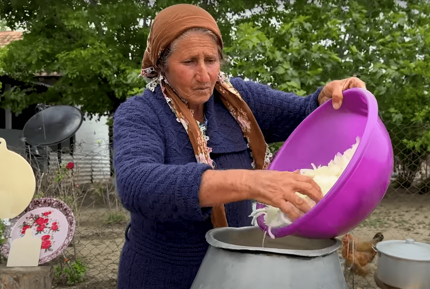 Elderly woman from Syria pours chopped onions into a large pot, symbolizing community contributions and resilience. Crypto-supported aid via XRP
