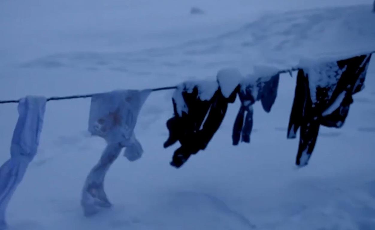 Winter relief for vulnerable families. Clothes on a clothesline in the snow, symbolizing hardship. Donate crypto like WBTC or WETH for warmth.