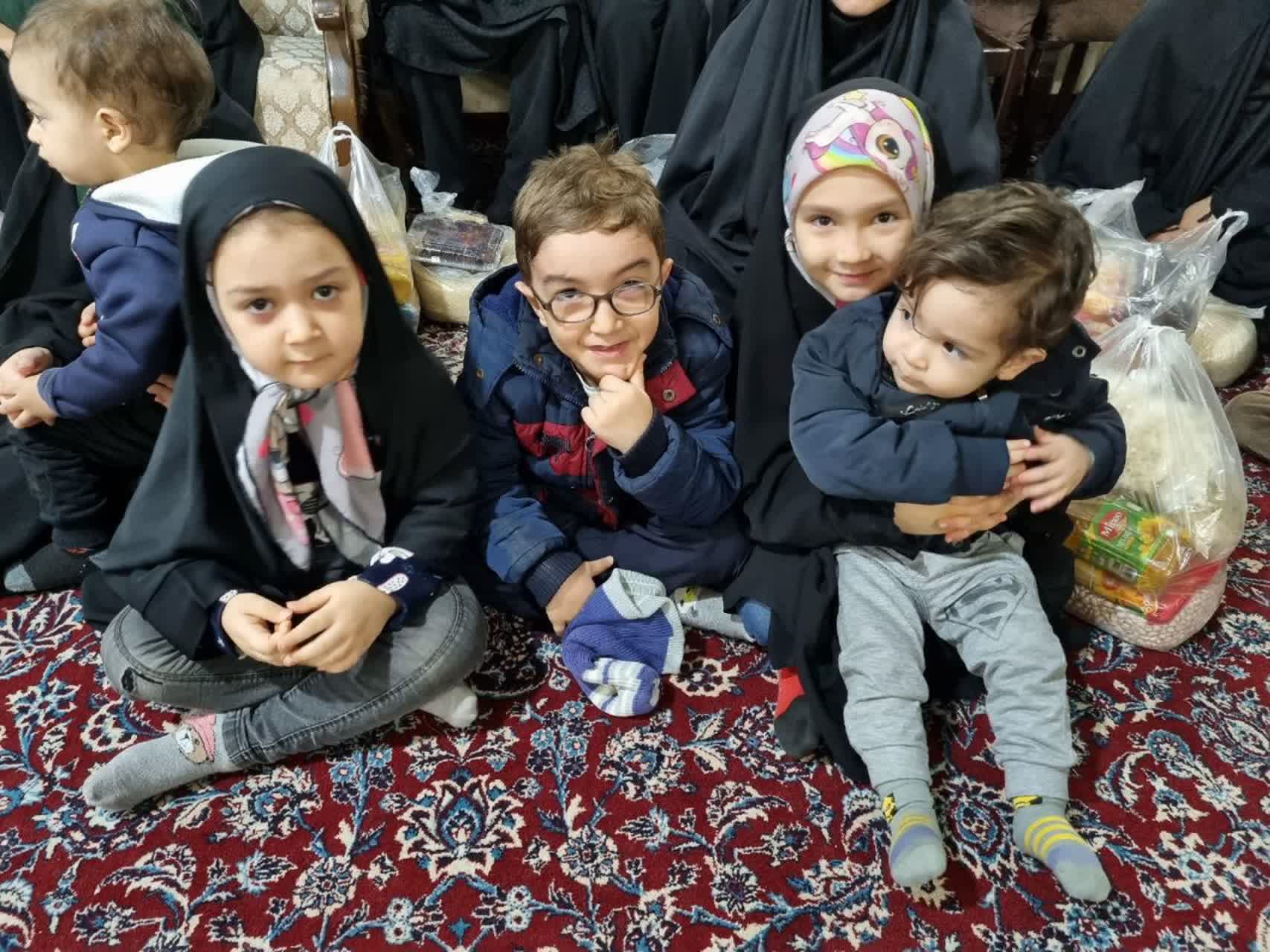 Children in traditional Islamic clothing sit together, receiving aid during Ramadan 2025, a testament to the strength and resilience of women, with support likely facilitated by crypto donations like USDS.