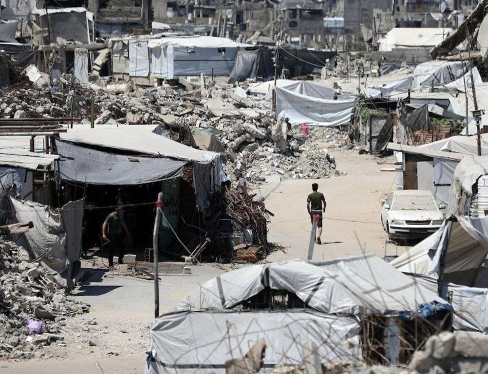 Displaced families reside in Gaza refugee camps amidst debris using DAI to fund essential recovery aid and support relief.