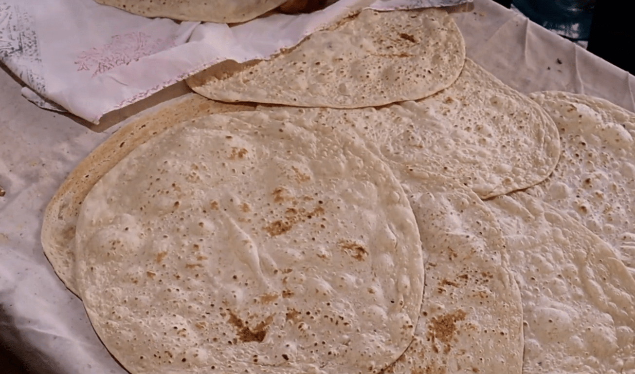 Stack of flatbread, representing food donations made via crypto for anonymous giving, with an emphasis on hidden sponsorship and humanitarian aid.