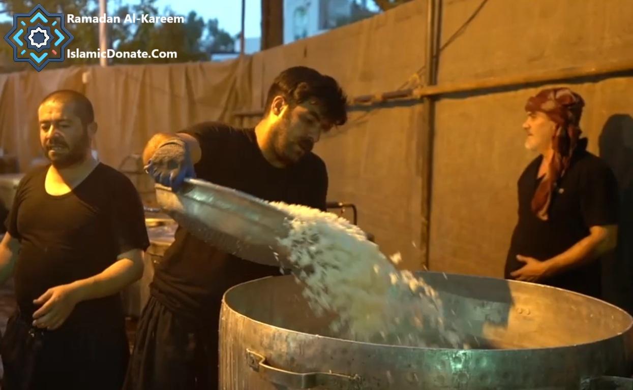Men serve rice into a large pot, providing 30,000 Iftar meals for needy families with cryptocurrency donations (Ripple USD).