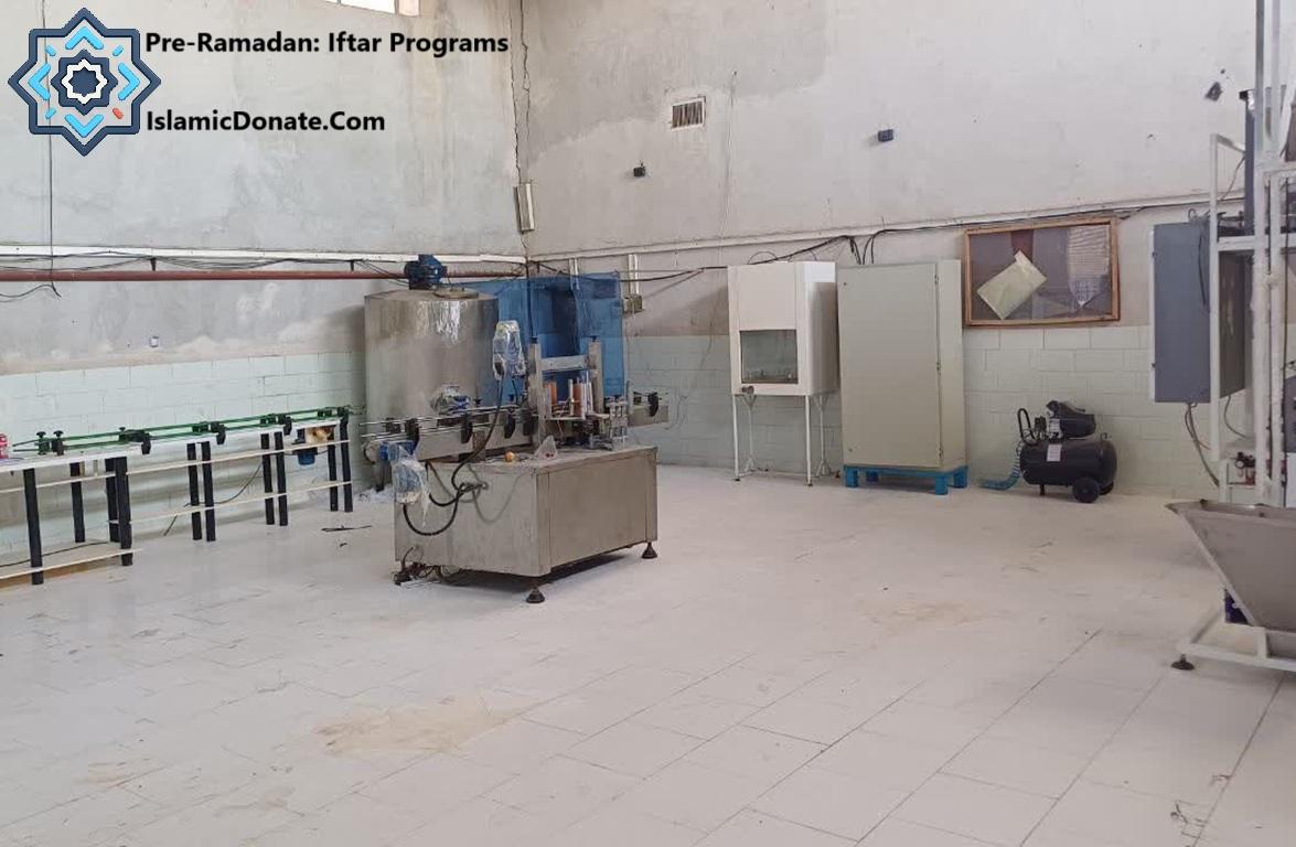 Noodle processing machinery in a warehouse funded by crypto donations like PYUSD for Ramadan food security.