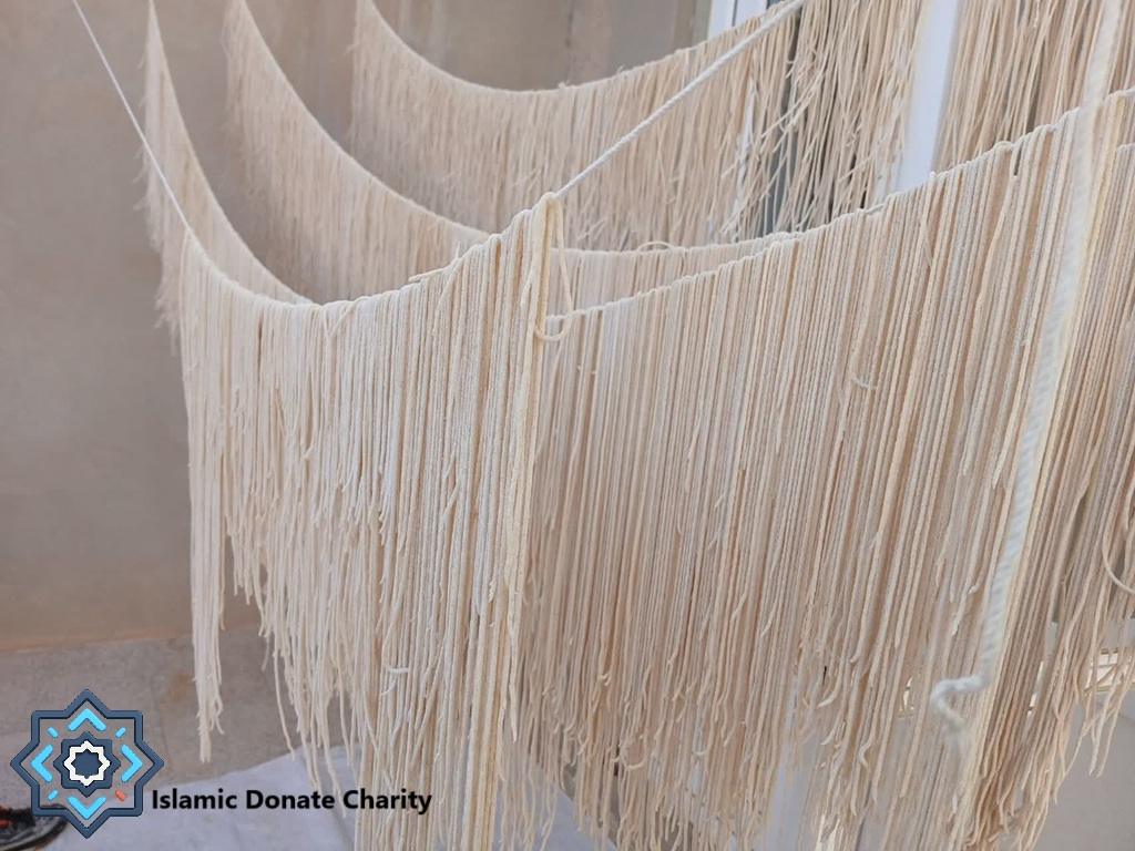Dried noodles hang outdoors, made possible by crypto donations like Ripple. Food security for Ramadan 2026.