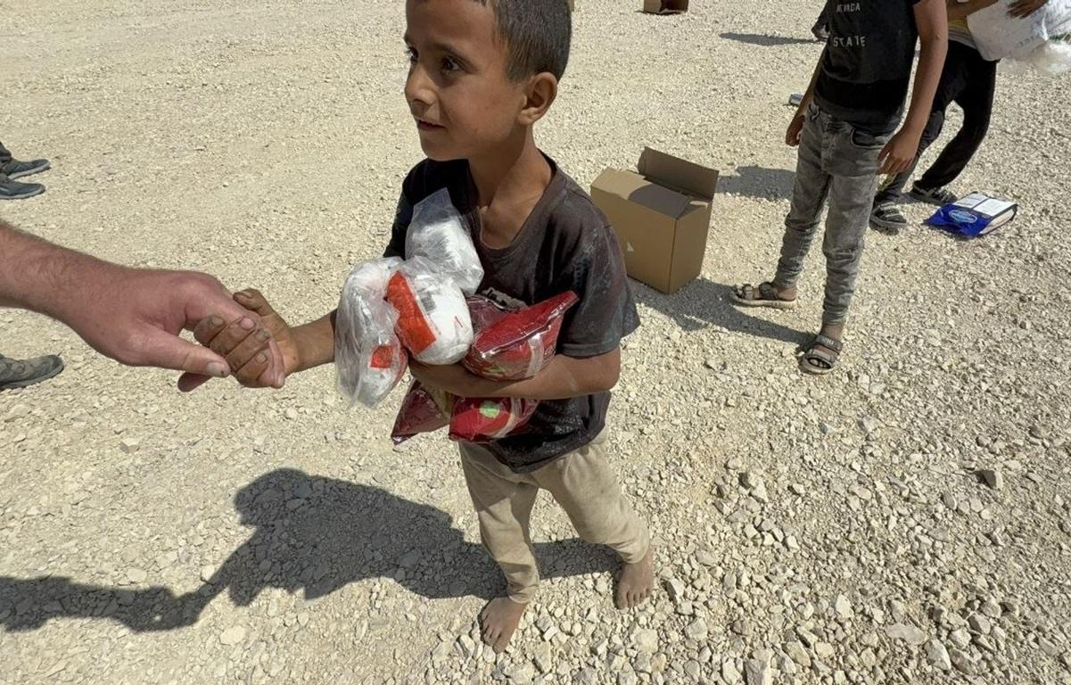 Anonymous impact boy receives food aid funded by Stablecoin crypto donation to stop crisis for families in need.