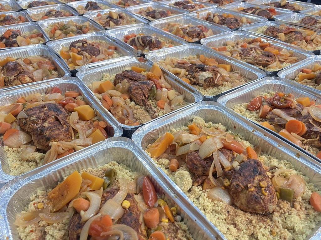 Qurbani crypto charity meals in foil containers distributed using USDT for Palestine relief and refugee aid.