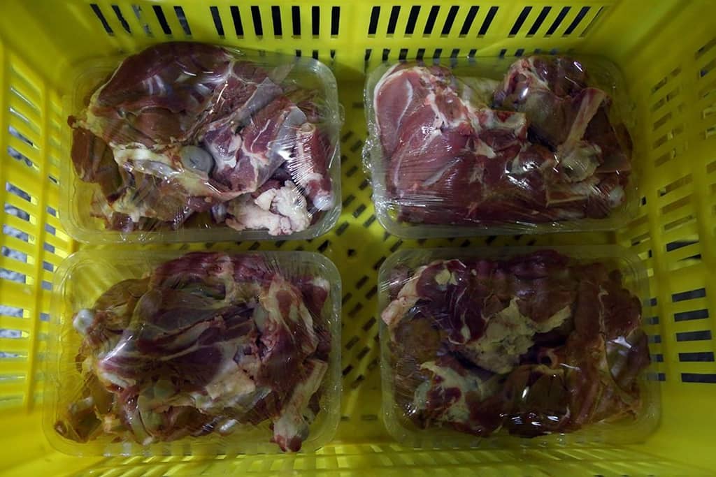 Four packages of raw sacrificial meat in a yellow crate, ready for distribution to families in need. Crypto donations enabled this Eid al-Adha mission, ensuring meat reaches vulnerable communities across Africa and Asia. Supported by ETH.