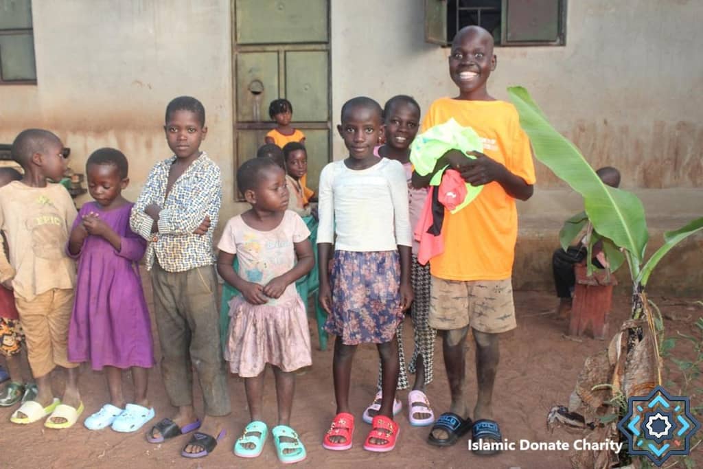 A diverse group of smiling children, some in new clothes, stand together. These children are receiving educational support through crypto donations. Their smiles show hope and futures empowered by ETH.