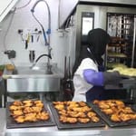 Halima, a devoted cook, prepares Iftar meals in a kitchen, showcasing her dedication to feeding the needy, with support from crypto donations like SOL.