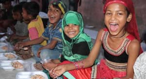 Joyful Muslim children eagerly eating iftar meals, their smiles bright. Your donations are enabling us to serve 1000 meals daily, made possible through ETH donations.