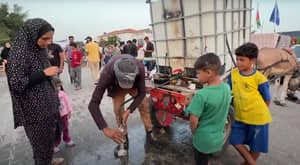People receiving aid including water distribution in Palestine, donation via Arab Emirates Dirham processing.