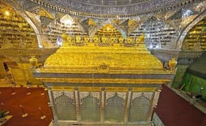 Ornate golden shrine with intricate tile work inside a mosque. Supports Islamic relief with crypto donations via USDT.