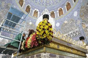 Preparations for a Shia Muslim religious event, with a large floral arrangement on a golden structure, supported by crypto donations via USDT.