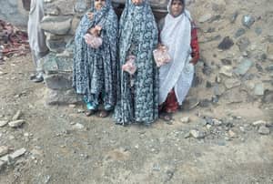 Three women receive meat donations, distribution of Qurbani through modern cryptocurrency like USDT, aiding needy Muslim communities in charitable endeavors.