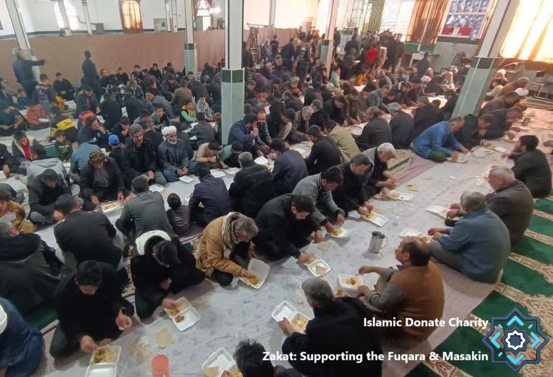 Give Zakat Online with Stablecoin to feed Masakin sharing hot meals at communal tables in Islamic Donate Charity masjid refugee camps.
