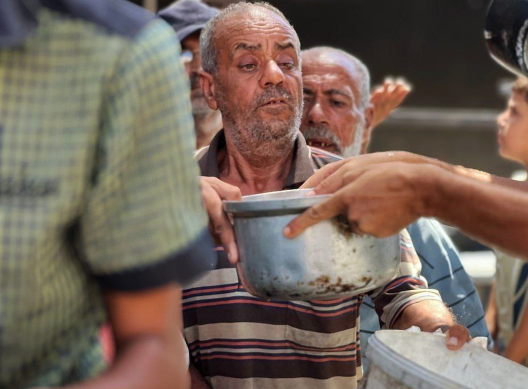 Palestinian man receives food aid via humanitarian support funded by WBTC donations for those in urgent need.