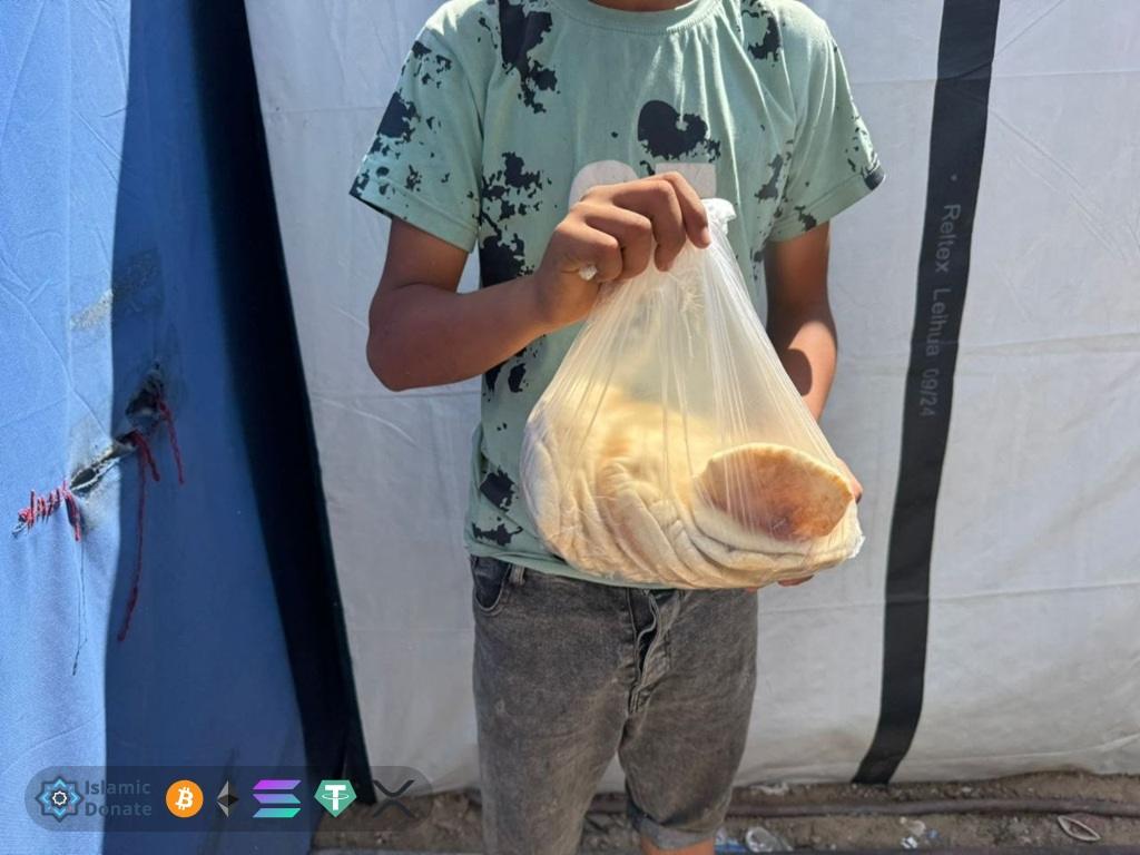 Boy hold fresh bread in Gaza. Private USDC impact supports family relief effort.