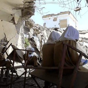 Children studying amidst destroyed classrooms, a testament to resilience empowered by crypto donations like BTC, reflecting the 49 orphans sponsored in the 2023-2024 academic year.