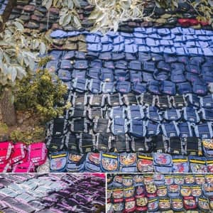 Rows of donated backpacks and school bags in various colors and designs, organized for distribution to children in need. This humanitarian effort for the Back to School report is supported by crypto donations, including ETH, empowering disadvantaged communities with educational resources. Sponsoring 200 orphans fosters a brighter future.