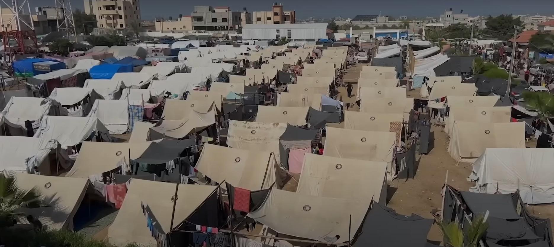 Tents in a Palestinian refugee camp, representing challenges in aid delivery, with a focus on food aid and sanitation, supported by crypto via SOL.