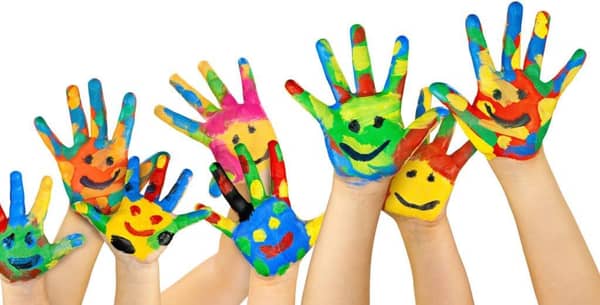Children's hands painted with colorful smiley faces, symbolizing hope and joy in orphan sponsorship, with crypto donations supporting global aid through RLUSD.