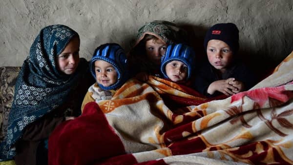 Children huddled together, showcasing the critical need for basic necessities like food, shelter, and healthcare for infants and orphans, supported by crypto donations via ETH.