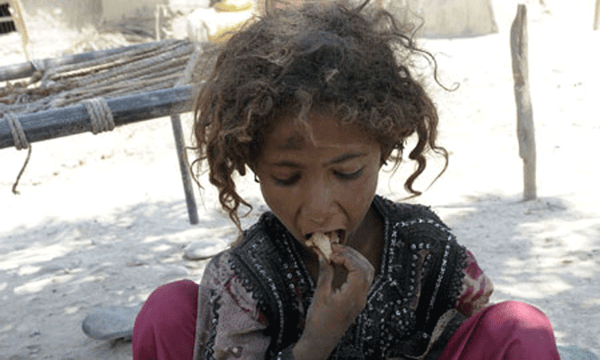 Child eating, implying aid is processed via USDT for humanitarian relief.