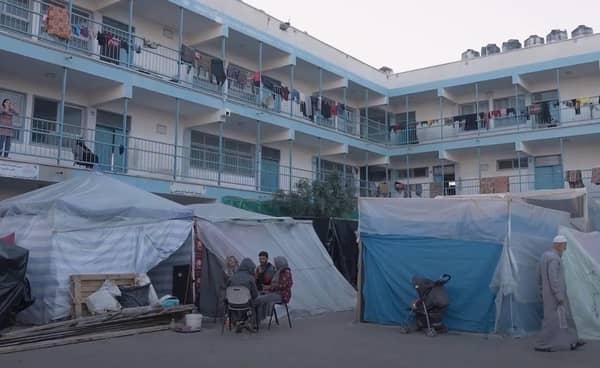 Aid to Gaza children receiving food and water delivered via crypto donations, facing new dangers as aid trucks are attacked; people live in makeshift shelters in Gaza.