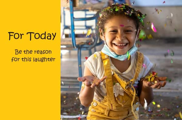 A happy child with confetti in their hair and hands outstretched, being the reason for laughter. Your donation, processed via ETH, supports urgent needs like meals and orphan sponsorship for today.
