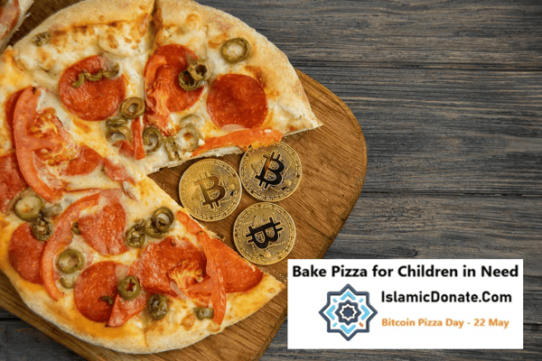 Pepperoni pizza with jalapenos and olives sits on a wooden board with Bitcoin coins. Crypto donations bake pizza for children in need on Bitcoin Pizza Day.