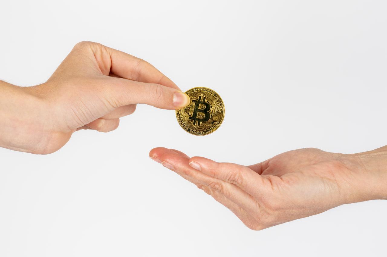 Giving Bitcoin for charity, representing secure digital currency donation and effective crypto giving methods. Supporting charitable organizations with Bitcoin.