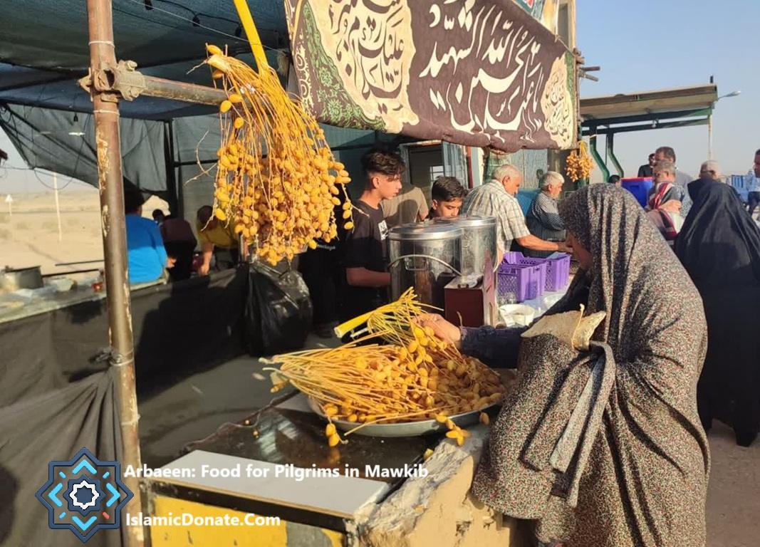 Arbaeen Pilgrims receive food and fresh dates funded by TRX donations at a roadside tent between Najaf and Karbala.