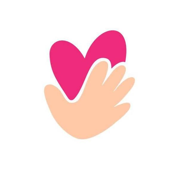 Hand holding a pink heart, symbolizing care and charity, with crypto donations processed via USDT for instant relief.